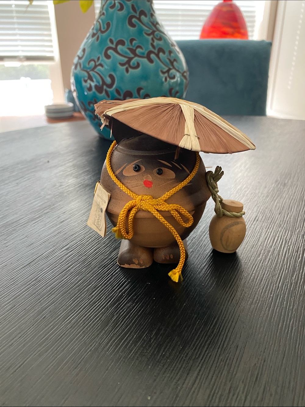 Vintage Japanese wooden folk art figurine depicts a tanuki (Japanese raccoon dog